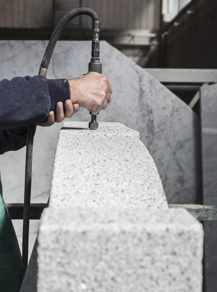 Worker cutting stone with precision